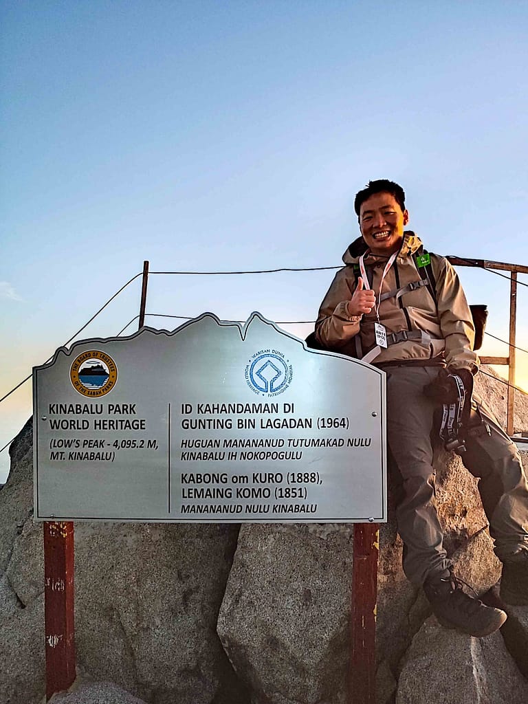 guy at top of Mount Kinabalu