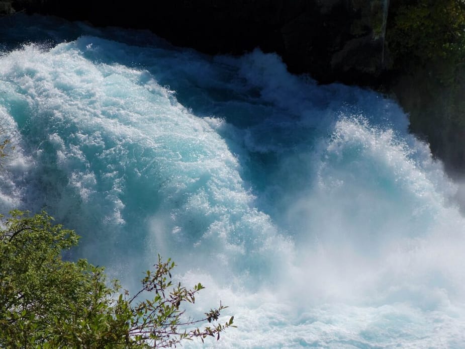 Icy blue water crashing to the water below at Huka Falls