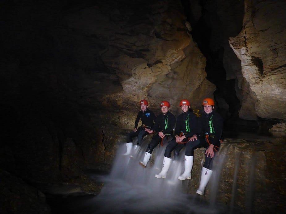 4 guys posing for a photo in Waitomo cave